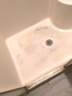 a white sink in a bathroom with no faucet or shower heads on it