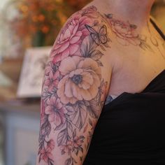 a woman's arm with flowers on it