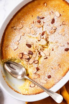 a dessert dish with almonds and powdered sugar on top, ready to be eaten