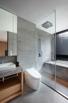 a bathroom with a toilet, sink and bathtub next to a large glass window