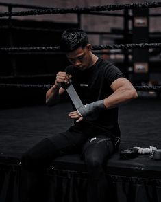 a man sitting on top of a table holding a knife