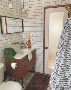 a bathroom with a sink, toilet and rug