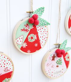 three christmas ornaments hanging on a white door