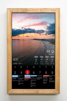 a wooden frame hanging on the wall displaying a calendar