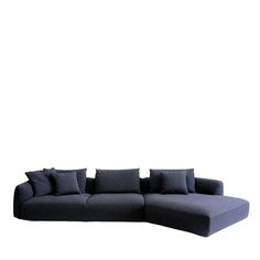 a large black couch sitting on top of a white floor