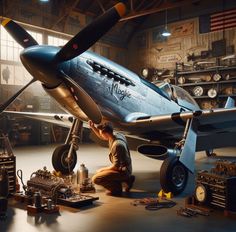 a man is working on an airplane in a garage with other tools and equipment around him