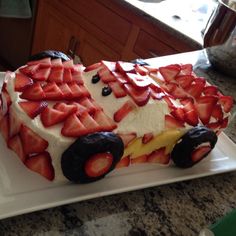 a cake made to look like a truck with strawberries on it