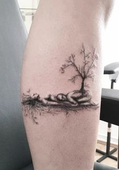 a woman's leg with a tree on it and roots growing out of it