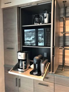 the coffee maker is sitting on top of the shelf in the kitchen cupboards,