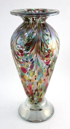 a colorful glass vase sitting on top of a table