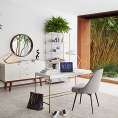 a living room filled with furniture and a large mirror on the wall next to a window