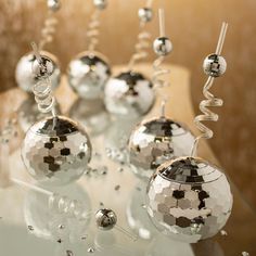 some shiny silver balls are sitting on a table