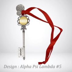 a key with a red ribbon around it and the words design alpha psi lamba 5