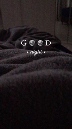 a black bed with the words good night written in white on it's side