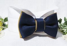 "Congratulations! You're planning a wedding. Let me help you make this day memorable by offering you an elegant wingtip tuxedo wedding collar and bow tie for your dog. Your dog will look fabulous and will help set the mood for your special celebration. In this listing, my classic bow tie is sewn on a pure white wingtip tuxedo collar. The navy blue and gold satin bow tie is made from polyester and is interfaced to provide additional support and shaping to the satin fabric. The top layer of the bo Acotar Wedding, Tuxedo Collar, Ring Bearer Dog, Dog Tuxedo, Navy Blue And Gold, Dog Ring, Tuxedo Wedding, Gold Satin, Dog Wedding