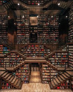 the library is full of books and has stairs leading up to each bookcases