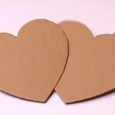 two cardboard hearts sitting on top of each other