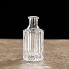 a clear glass vase sitting on top of a wooden table