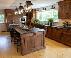 a large kitchen with wooden cabinets and an island