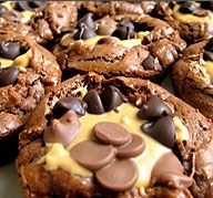 several cookies with chocolate chips and melted cheese on top are sitting on a white plate