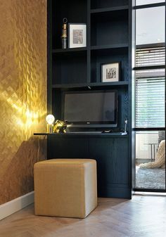 a living room with built in shelves and a television