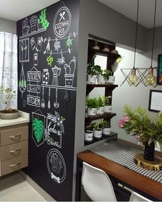 a chalkboard wall in a kitchen with potted plants