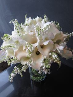 a vase filled with white flowers on top of a table