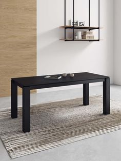 a black table sitting on top of a rug in front of a wall mounted shelf