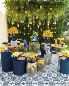 blue and yellow dessert table with lemons, oranges, and watermelon