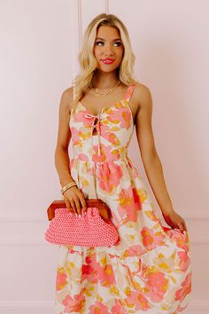 – Stay sweet and stunning in our beautiful dress – Lightweight, 100% polyester material patterned in a yellow and pink hued floral print – Fully lined bodice with a soft skirt slip – V-cut neckline with cutout and tie closure accent – Fitted bodice with a straight smocked back – Sleeveless 1-inch shoulder straps – Relaxed tiered skirt silhouette that falls into a straight hemline Measurements S : Bust 30", Hip 34", Length 40.5", Waist 26". M : Bust 32", Hip 36", Length 41", Waist 28". L : Bust 3 Floral Print Sundress With Sweetheart Neckline For Spring, Spring Floral Print Sundress With Sweetheart Neckline, Spring Floral Sundress With Sweetheart Neckline, Chic Pink Sundress With Tie Back, Beige Floral Print Sundress With Spaghetti Straps, Floral Print Sundress With Sweetheart Neckline, Pink Sweetheart Neckline Dress For Vacation, Pink Sundress With Spaghetti Straps And Floral Print, Pink Sundress With Floral Print And Spaghetti Straps