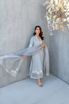 SKU: 2206 Price for Shirt, lining & Pants The iridescent and resplendence of dusty gray come together to create this stunning ensemble, rendered in soft silk fabric festooned with pearls, crystals and Hand worked florals. This ensemble comes with organza dupatta embellished with delicate details of laces an pearls with hand made florals. Dupatta as is can be added. Elegant Gray Sets For Eid, Elegant Gray Set With Dupatta, Elegant Gray Festive Sets, Gray Wedding Sets For Eid, Designer Work Dresses, Pakistani Designer Dress, Dusty Gray, Pakistani Wedding Dress, Desi Clothes