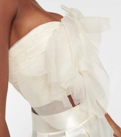 style details: Bring Danielle Frankel's romantic aesthetic to your cocktail edit with the Macie strapless bustier. The ethereal style is crafted from frothy silk organza layers into the shape of a rose and has soft boning for a structured look. material: 100% silk; care instructions: dry clean; zipped back; Made in the USA; built-in bustier; Designer colour name: Ivory.size & fit: If you have any questions, please call our customer care team at 0808 101 3473 True to size; Strapless; Internal boned corset for support; Fitted; Mid-weight material; Cropped; Padded top; The model seen in the picture is 178cm-5'10' and wearing a size US 4.delivery & free returns: All orders are shipped worldwide via our affiliate couriers DHL or UPS. Please see the shipping method as well as shipping costs and Elegant Spaghetti Straps Bodice With Boned Bodice, Evening Organza Corset With Sweetheart Neckline, Organza Corset With Fitted Bodice For Prom, Elegant Corset With Delicate Straps, Elegant Party Tube Top With Lined Bodice, Elegant Sheer Corset For Party, Feminine Strapless Corset For Party, Summer Evening Corset With Sheer Bodice, Sheer Fitted Wedding Corset