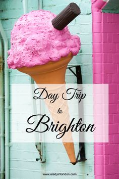 an ice cream cone with pink frosting on it and the words, day trip to brighton