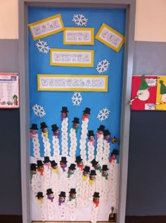 a classroom door decorated with snowmen and hats