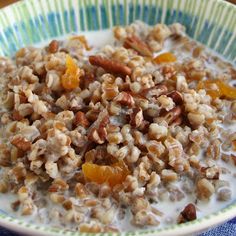 a bowl filled with oatmeal and nuts on top of a table