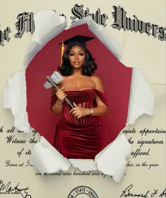 a woman in a graduation gown holding a hammer and posing for a photo through torn paper