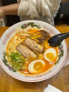 a bowl of ramen with eggs, noodles and meat