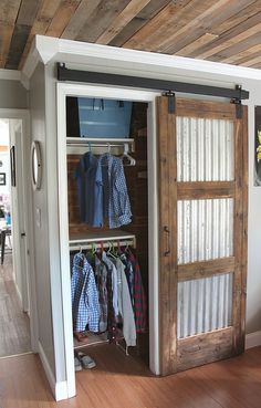 an open barn door with clothes hanging in it