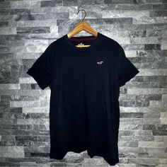 Navy Blue Hollister T-Shirt Size: Large Never Worn Without Tags Navy Crew Neck Graphic Tee, Navy Graphic Tee With Crew Neck, Navy Graphic Tee Shirt With Crew Neck, Navy Graphic Tee With Short Sleeves, Basic Navy Short Sleeve T-shirt, Navy Casual Crew Neck T-shirt, Casual Navy T-shirt With Crew Neck, Navy Casual Crew Neck Top, Casual Navy Crew Neck T-shirt