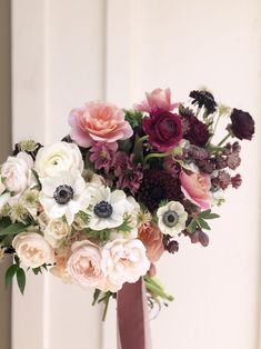 a vase filled with lots of different colored flowers