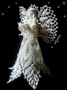 an angel made out of crochet on a black background