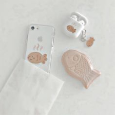 an iphone case with fish and sea animals on it sitting next to some other items