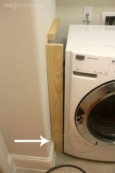 a white washer sitting next to a dryer in a room