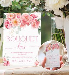 a bouquet bar sign sitting on top of a table next to vases filled with flowers