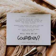 a card that reads, will you be my god father? with scissors on it