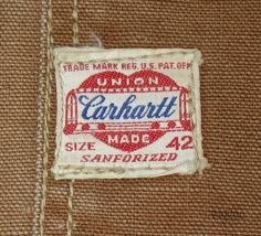 an old label on the back of a brown jacket with red and white lettering that says, union carnarti made in san francisco