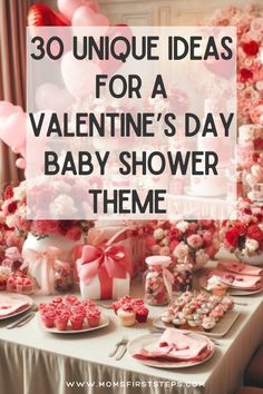 valentine's day baby shower theme with pink flowers and hearts on the table in front of