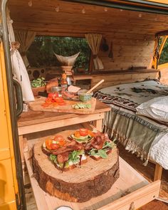 the interior of a camper with food in it's bed and on the side