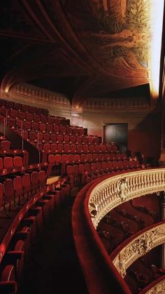 an empty auditorium with red seats and ornate railings