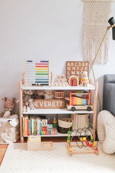 a book shelf filled with lots of books and toys